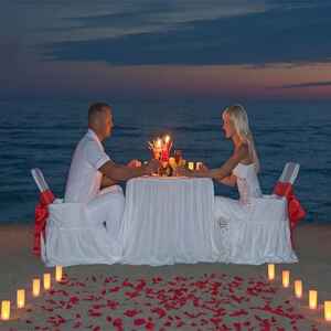Couple's are enjoying their candle light dinner on the beach on their honeymoon in Goa